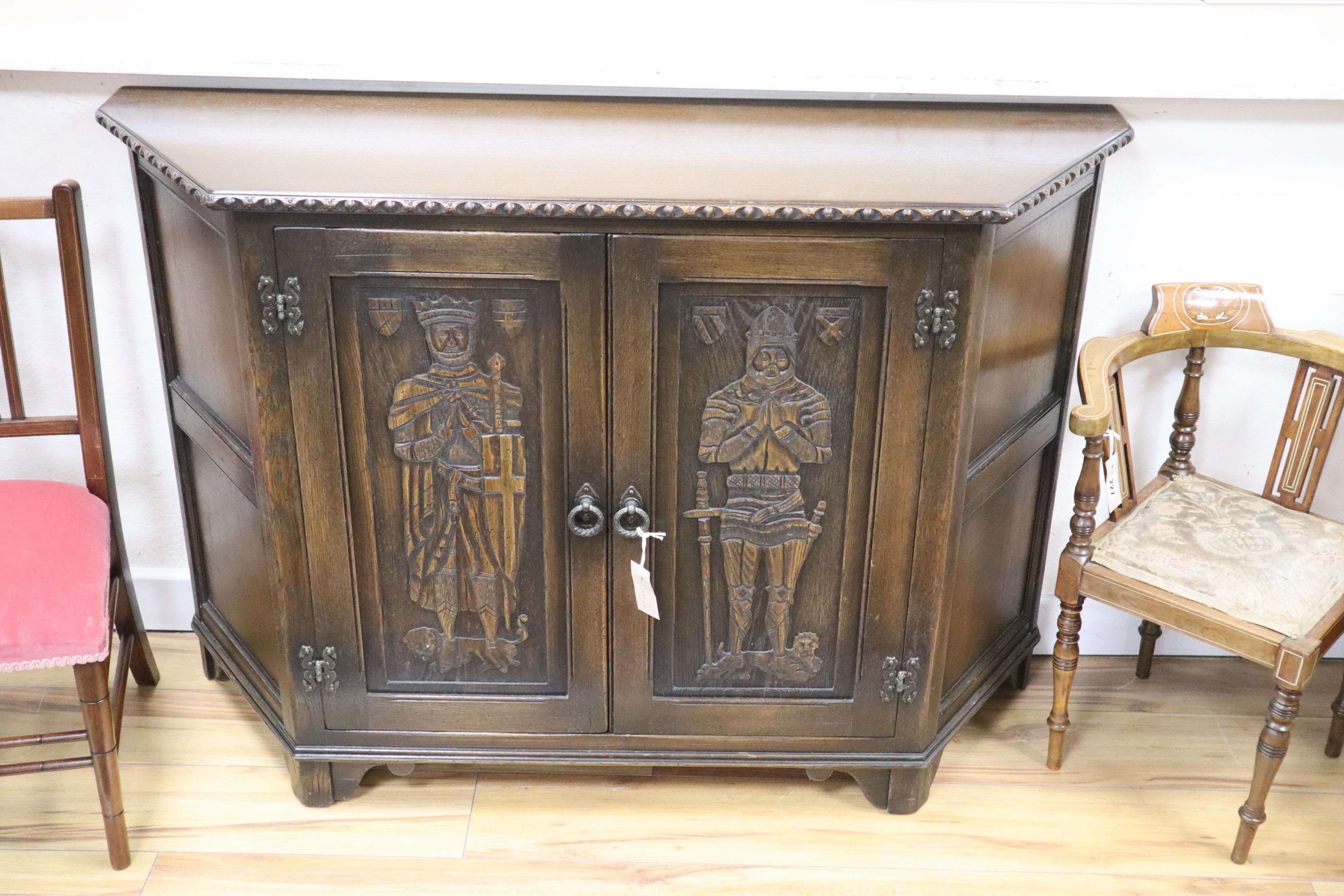 A medieval style carved oak side cabinet, width 120cm, depth 38cm, height 81cm